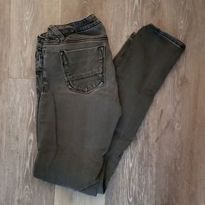 Distressed black skinny jeans